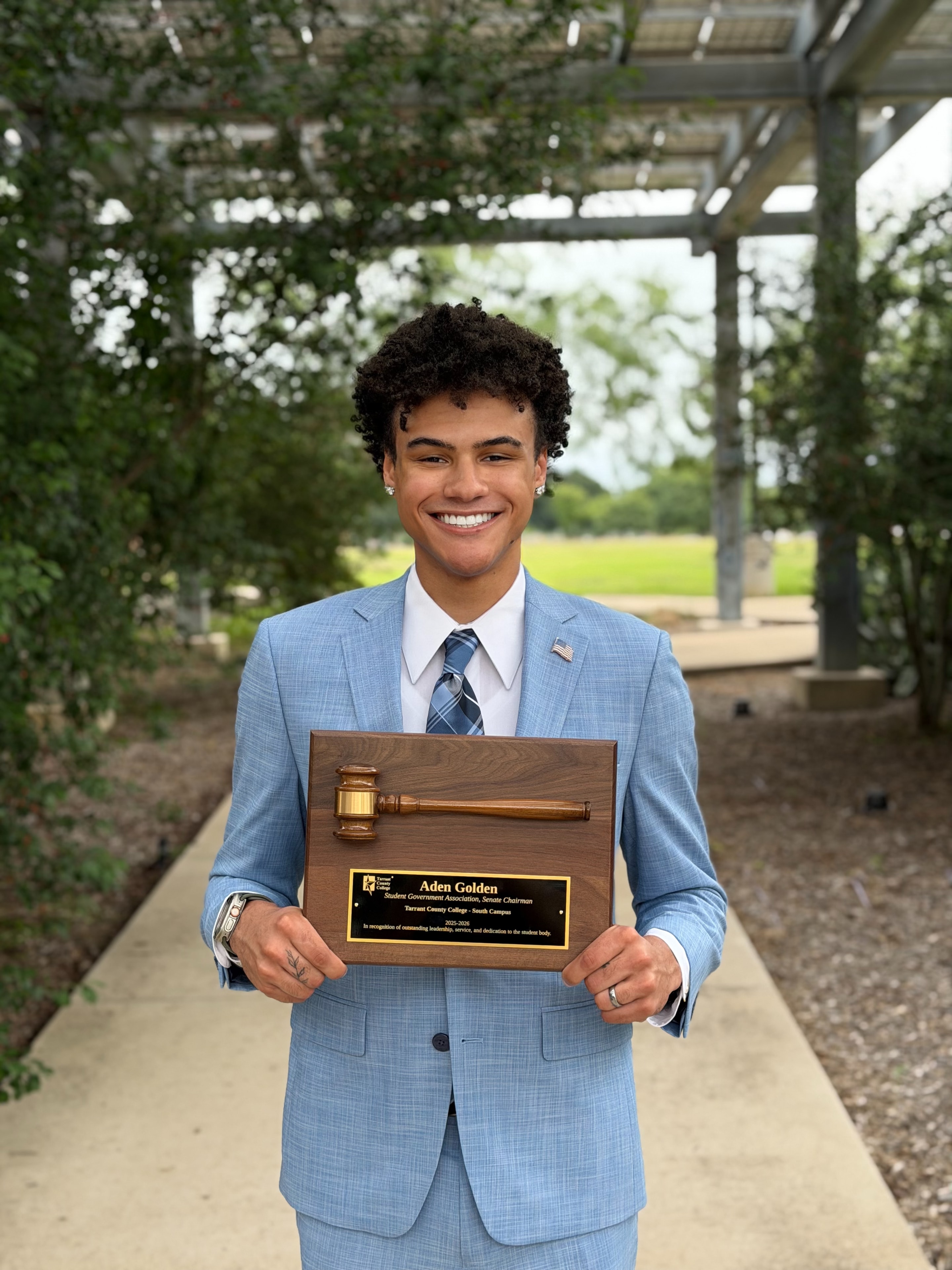 Aden Golden receiving an award for his hard work and dedication to students of TCC while serving as Senate Chairman